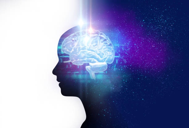 picture of the brain, glowing light blue, against the dark navy blue silhouette of a person dividing the picture in half, white and galaxy blue