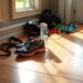 running shoes and other running gear in the light of sunlight coming from a window, on a plywood floor. to symbolize reducing friction between the action and follow through, which helps one stay disciplined